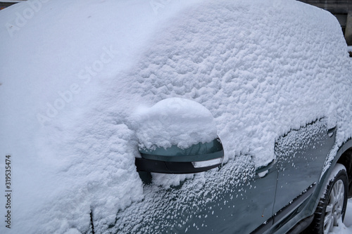 A car covered with a thick layer of snow closeup. © Anatoliy
