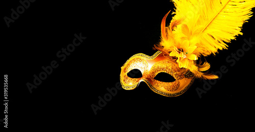 Fototapeta Naklejka Na Ścianę i Meble -  Golden Carnival mask on black background. Mardi Gras concept. Copy space