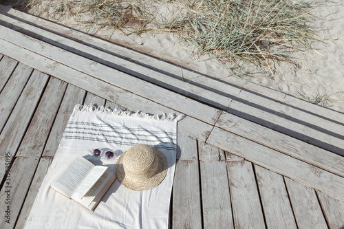 Foto Boho eco styled beach essentials on sand by sea