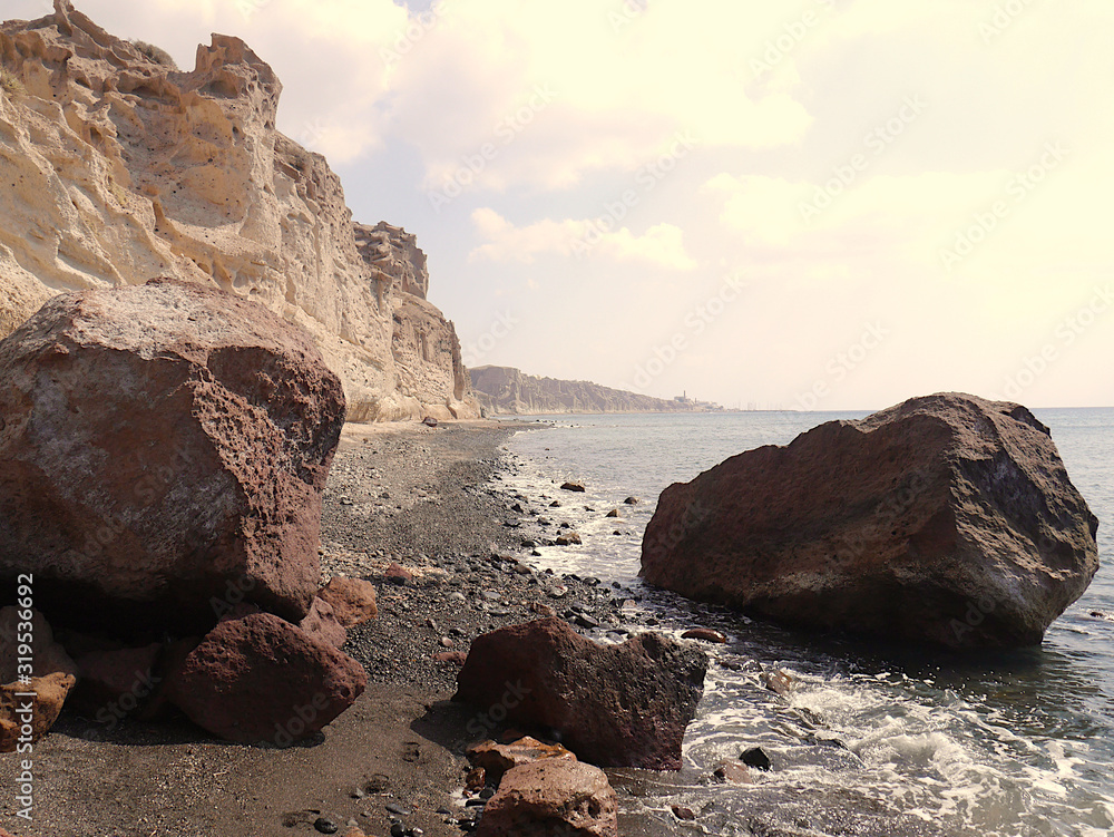 Fototapeta premium Landscape with cliffs and large stones on the coast near Akrotiri. Santorini, Greece.