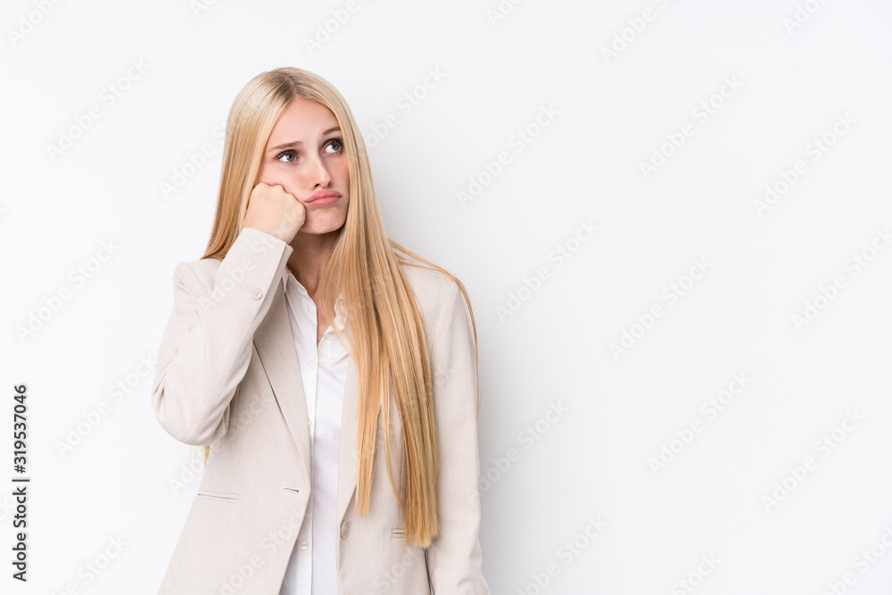 Young business blonde woman on white background who feels sad and pensive, looking at copy space. Young business blonde woman on white background who feels sad and pensive, looking at copy space.