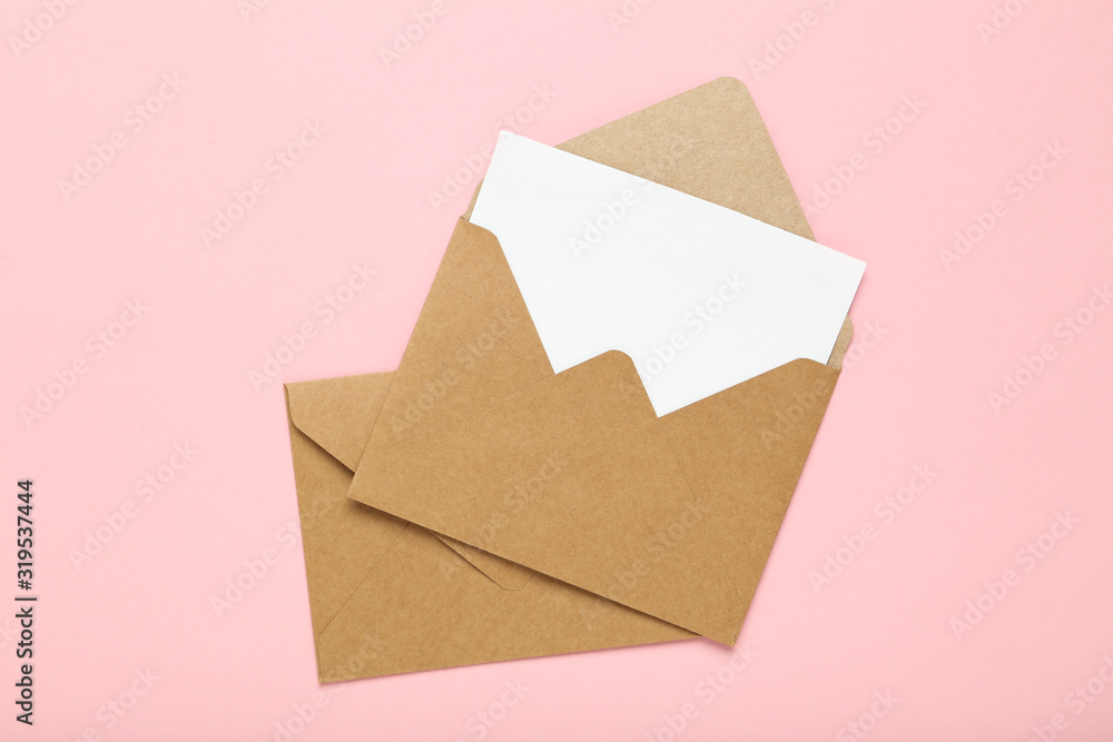 Brown paper envelopes on pink background Brown paper envelopes on pink background
