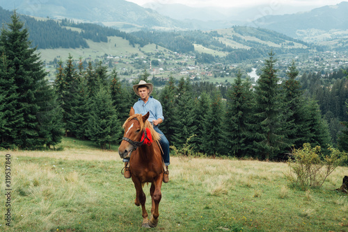 Cowboys riding a horse over the mountains