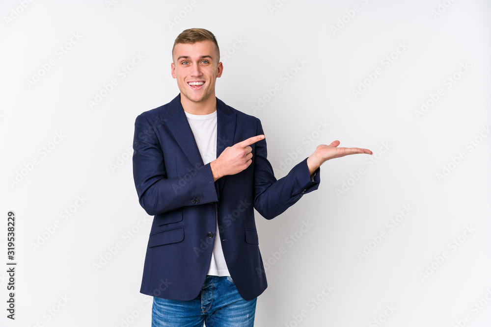 Young business caucasian man excited holding a copy space on palm. Young business caucasian man excited holding a copy space on palm.