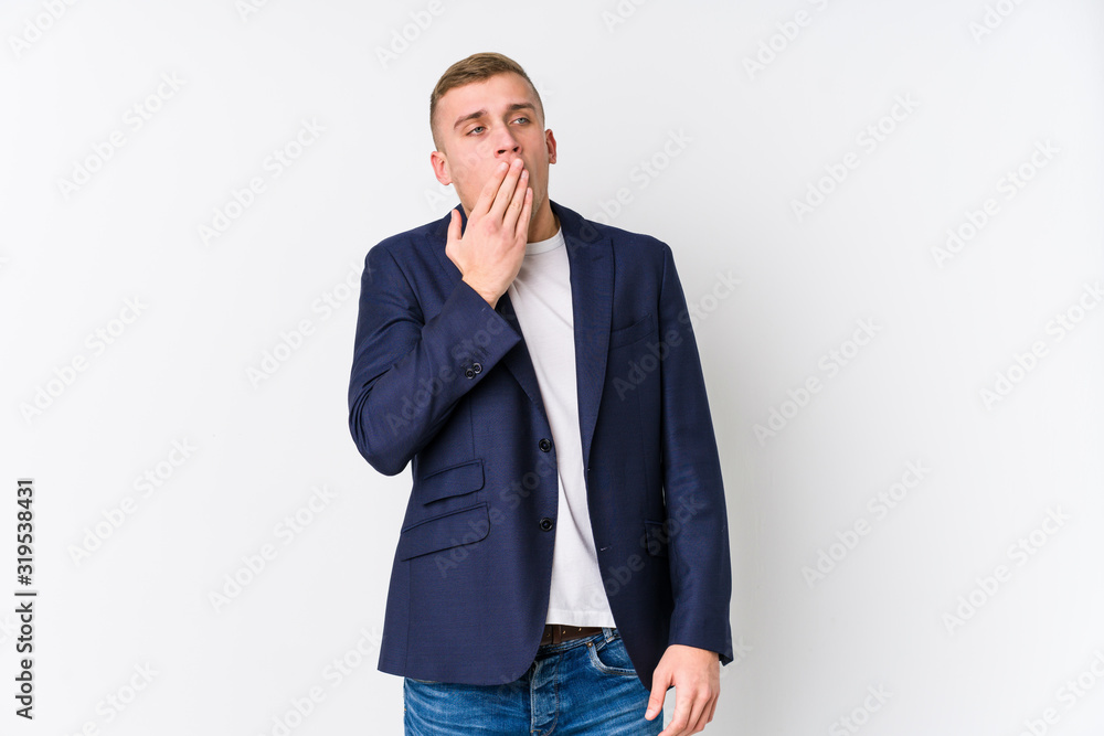 Young business caucasian man yawning showing a tired gesture covering mouth with hand. Young business caucasian man yawning showing a tired gesture covering mouth with hand.