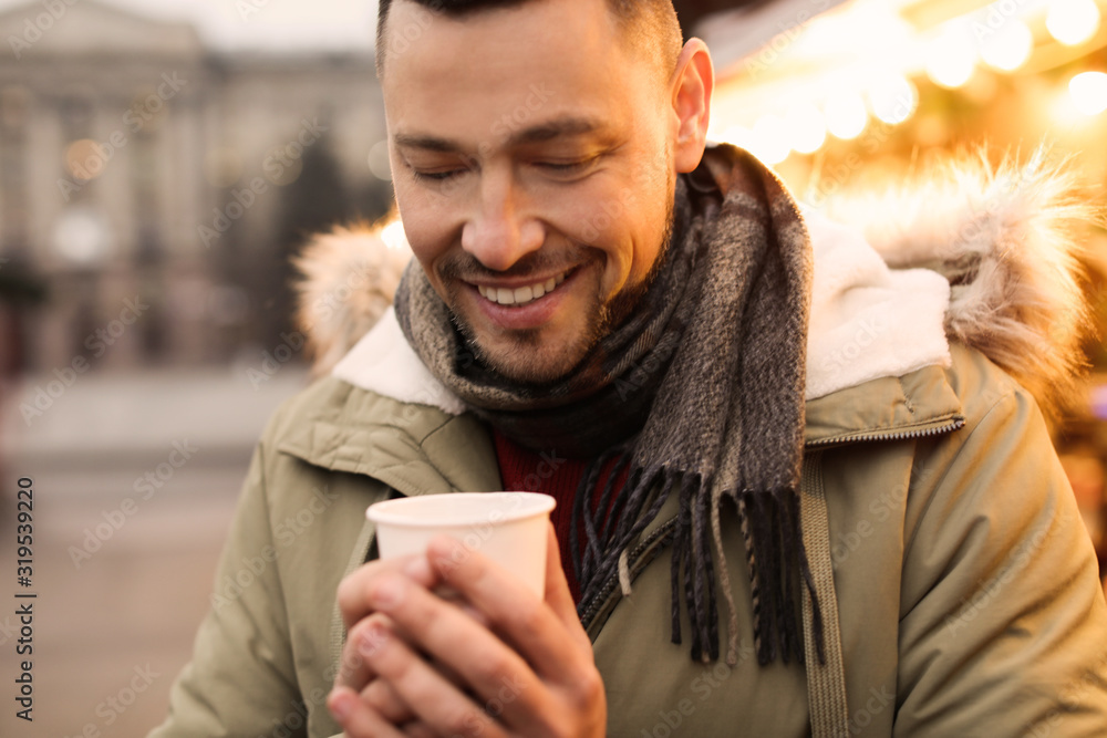 Happy man with mulled wine at winter fair Happy man with mulled wine at winter fair