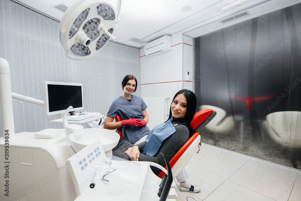 Doctor and patient look at the camera, smile health. Dentistry Doctor and patient look at the camera, smile health. Dentistry