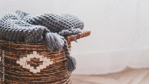 Wicker basket with warm woolen blanket