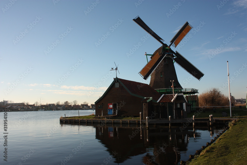 mill in Amsterdam on the Zaandam river at sunset