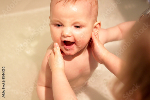 older sister helps swim younger sister