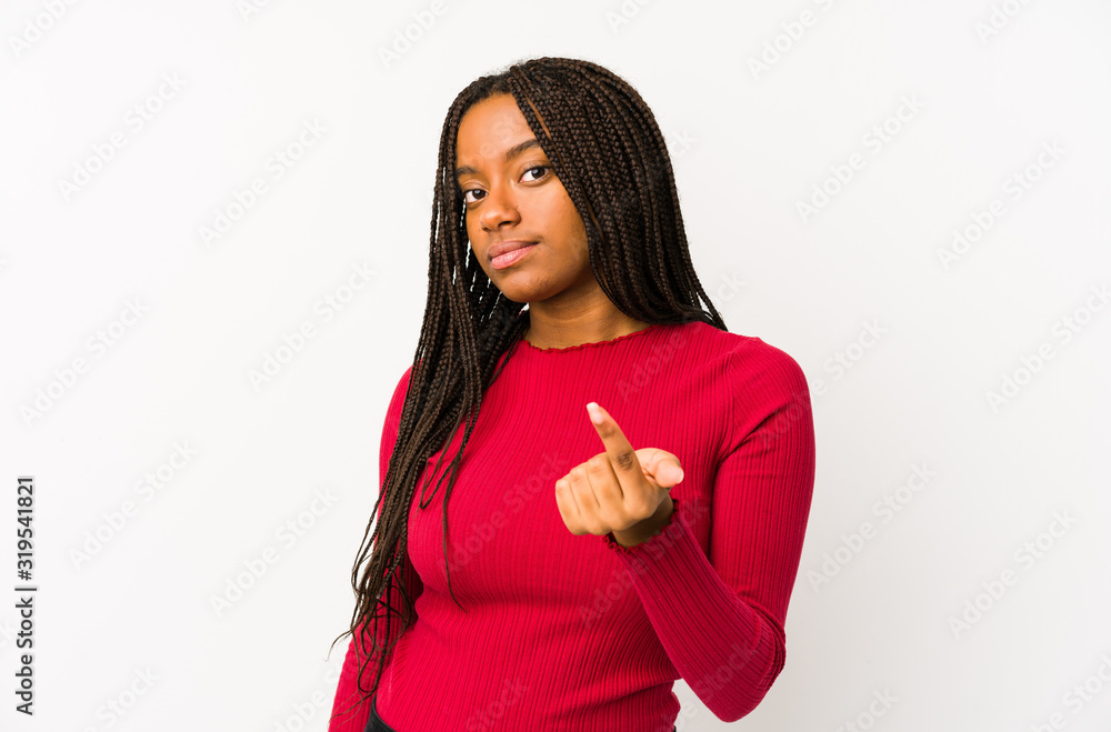 Young african american woman isolated pointing with finger at you as if inviting come closer. Young african american woman isolated pointing with finger at you as if inviting come closer.