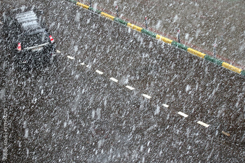 Snowfall on the road. Stylish image 