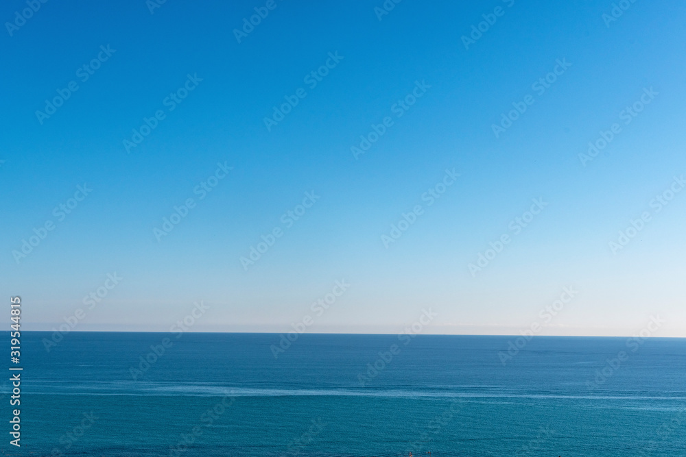 Clear sky and calm sea or ocean water surface