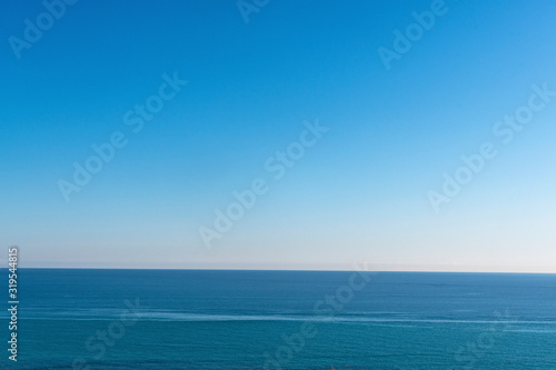 Clear sky and calm sea or ocean water surface