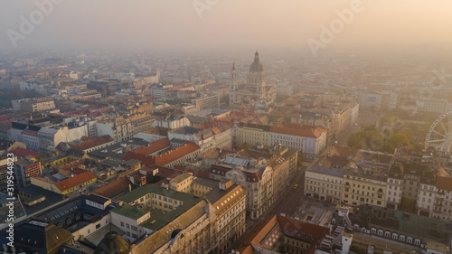 Top view shooting on a drone in the early morning. City is the capital of Hungary, sunrise of the sun. Historical part of the old city Budapest, towers St. Stephen's Cathedral.
