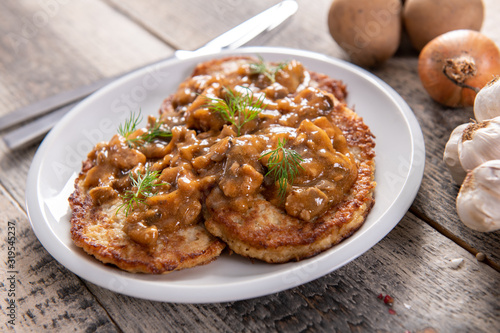Tasty homemade potato pancakes with meat and mushrooms