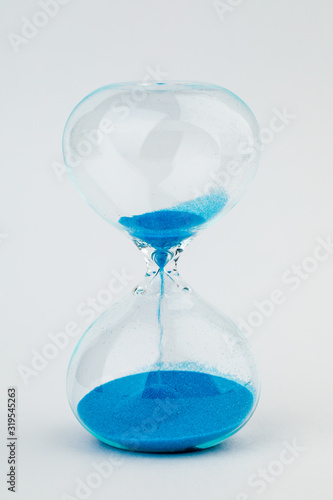 Hourglass as a concept of passing time. On white background