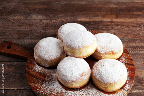 German donuts with jam and icing sugar. Carnival powdered sugar raised donuts for party