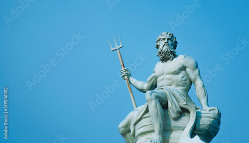 Fotografie, Obraz Ancient stone statue of mighty god of the sea and oceans Neptune (Poseidon) with trident