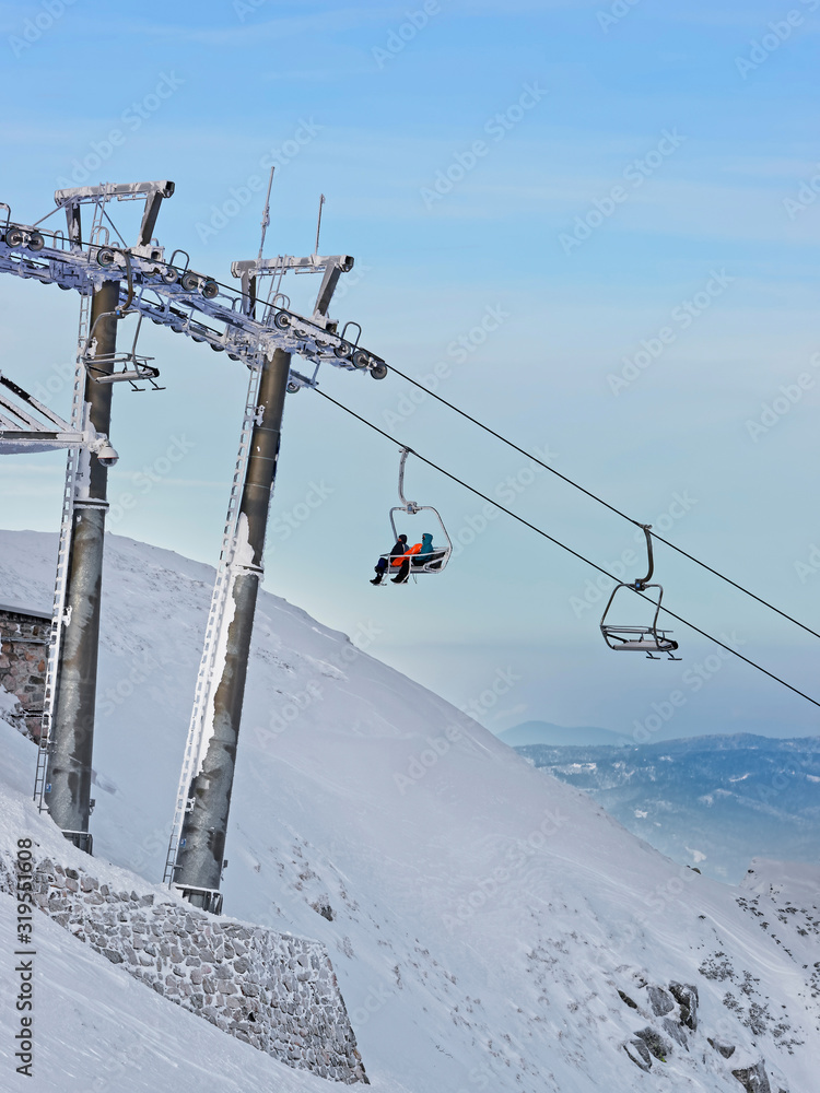 Chair lifts with people in Kasprowy Wierch in Zakopane in winter. Zakopane is a town in Poland in Tatra Mountains. Kasprowy Wierch is a mountain in Zakopane and is the most popular ski area in Poland Chair lifts with people in Kasprowy Wierch in Zakopane in winter. Zakopane is a town in Poland in Tatra Mountains. Kasprowy Wierch is a mountain in Zakopane and is the most popular ski area in Poland