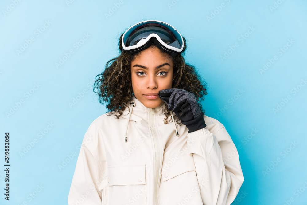Young african american skier woman isolated with fingers on lips keeping a secret. Young african american skier woman isolated with fingers on lips keeping a secret.