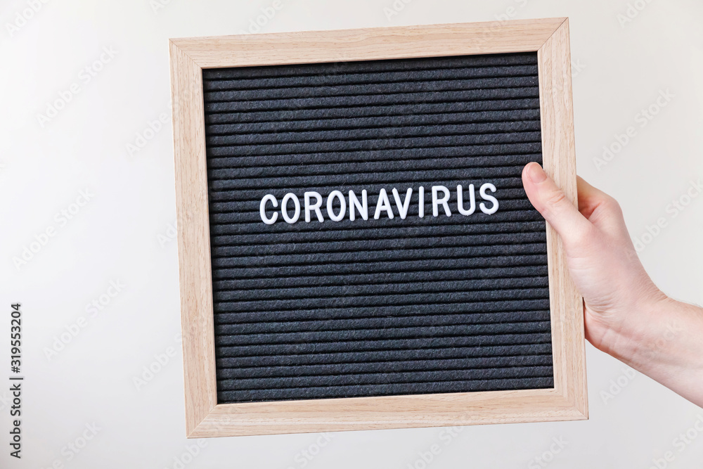 Woman hand holding black letter board with text phrase Coronavirus. Novel coronavirus 2019-nCoV, MERS-Cov middle East respiratory syndrome coronavirus originating in Wuhan China Woman hand holding black letter board with text phrase Coronavirus. Novel coronavirus 2019-nCoV, MERS-Cov middle East respiratory syndrome coronavirus originating in Wuhan China