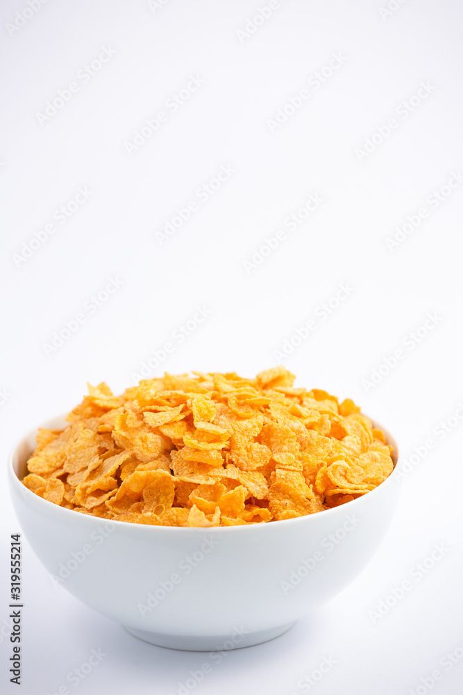 Natural corn flake breakfast cereal in cups and milk is a healthy breakfast that is good for your body every day on a white background. Natural corn flake breakfast cereal in cups and milk is a healthy breakfast that is good for your body every day on a white background.