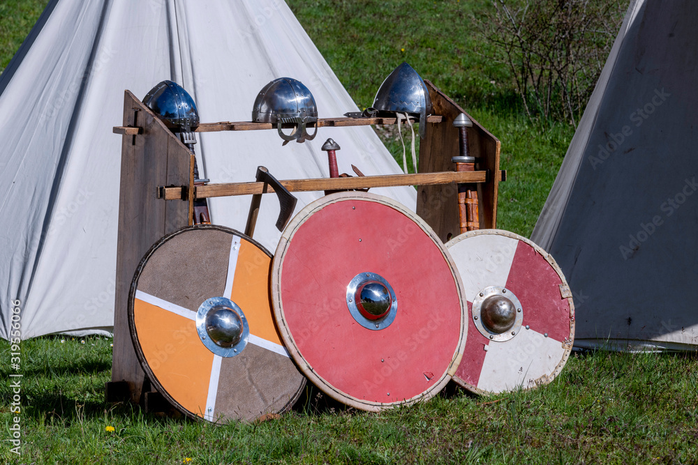 Viking shields, helmets and swords, in a Viking camp