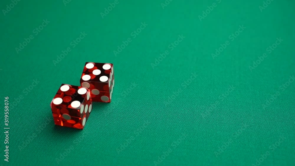 The shooter rolls nine in craps. Slow motion two red dice, craps, thrown on green tomentum background at casino, Nina. Gambling game with random result for adults. The shooter rolls nine in craps. Slow motion two red dice, craps, thrown on green tomentum background at casino, Nina. Gambling game with random result for adults.