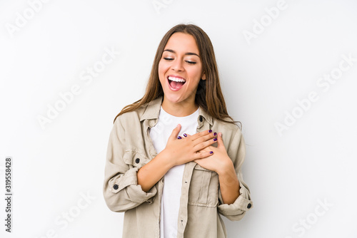 Young caucasian woman isolated laughing keeping hands on heart, concept of happiness.