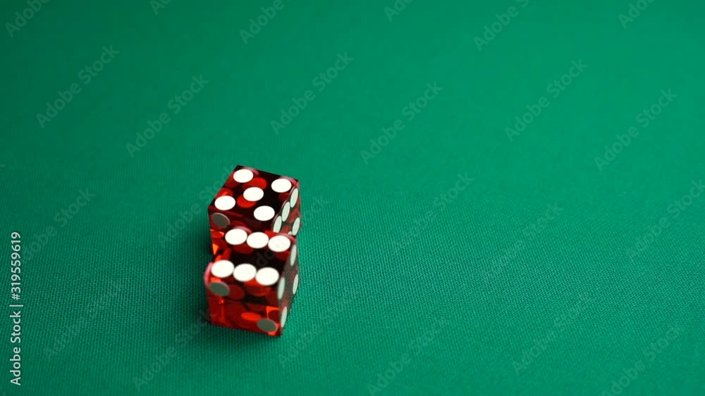 The shooter rolls eleven in craps. Slow motion two red dice, craps, thrown on green tomentum background at casino, Yo or Yo-leven. Gambling game with random result for adults. The shooter rolls eleven in craps. Slow motion two red dice, craps, thrown on green tomentum background at casino, Yo or Yo-leven. Gambling game with random result for adults.