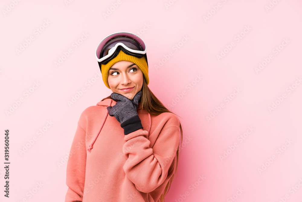 Young caucasian woman wearing a ski clothes isolated looking sideways with doubtful and skeptical expression. Young caucasian woman wearing a ski clothes isolated looking sideways with doubtful and skeptical expression.
