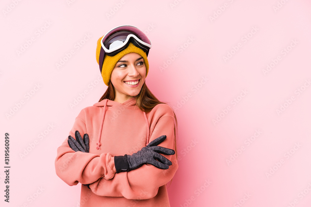 Young caucasian woman wearing a ski clothes isolated smiling confident with crossed arms.