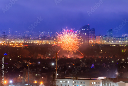 Holiday fireworks in a city with blue night sky