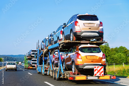 Cars carrier truck at the asphalt highway in Poland. Truck transporter