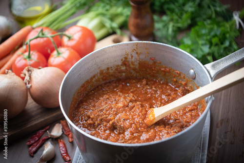 bolognaise sauce in pot with ingredients background photo