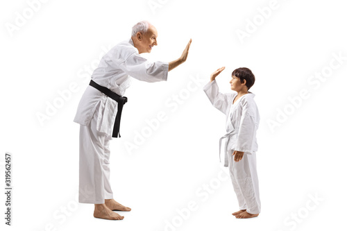 Karate boy and an elderly man gesturing high-five