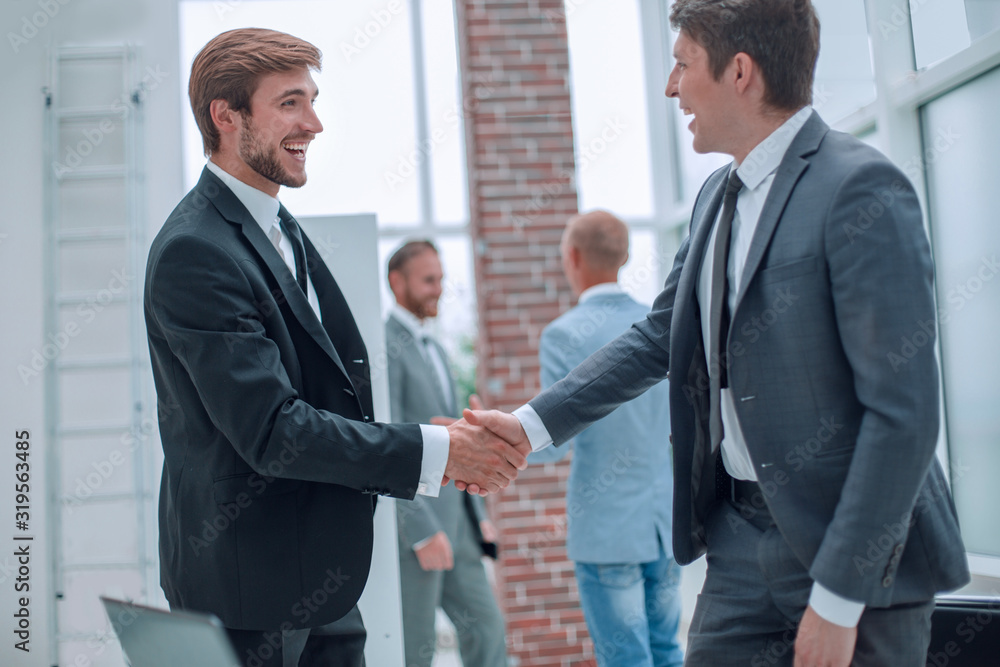 happy business people shaking hands in the office. happy business people shaking hands in the office.