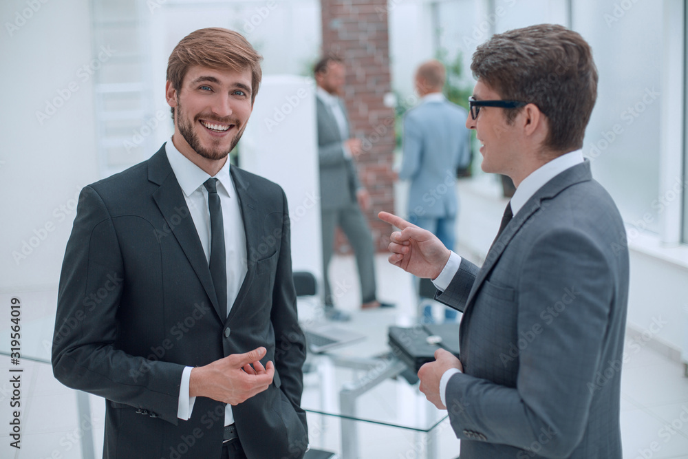 employees discuss their ideas standing in the office. employees discuss their ideas standing in the office.
