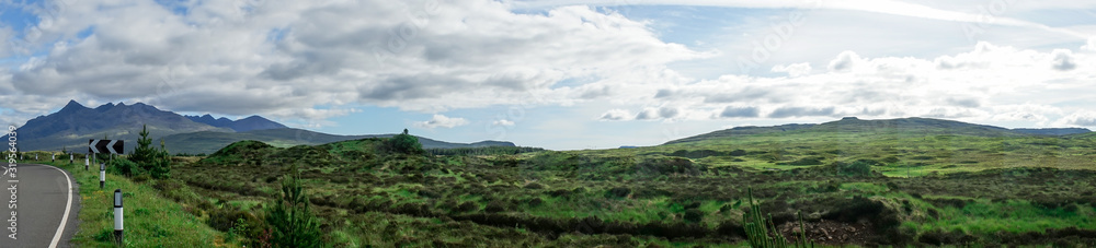 Panorama of clear, green highlands at the roadside