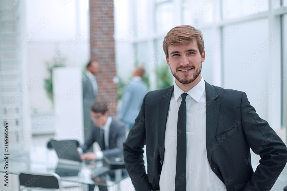 close up. smiling businessman standing in his office. close up. smiling businessman standing in his office.