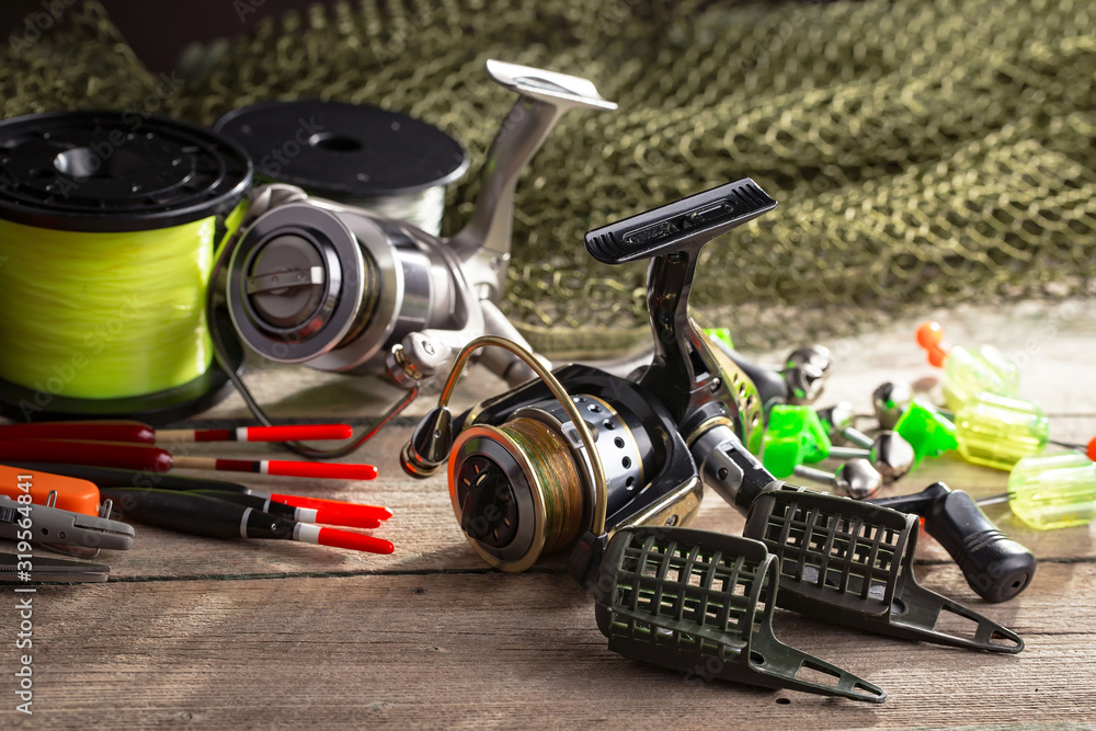 fishing tackle on a wooden table. toned image fishing tackle on a wooden table. toned image