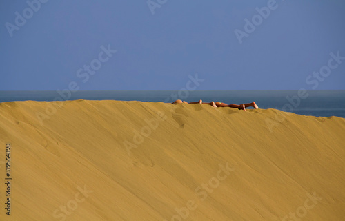 Sunbathers on the Ridge of a Sand Formation