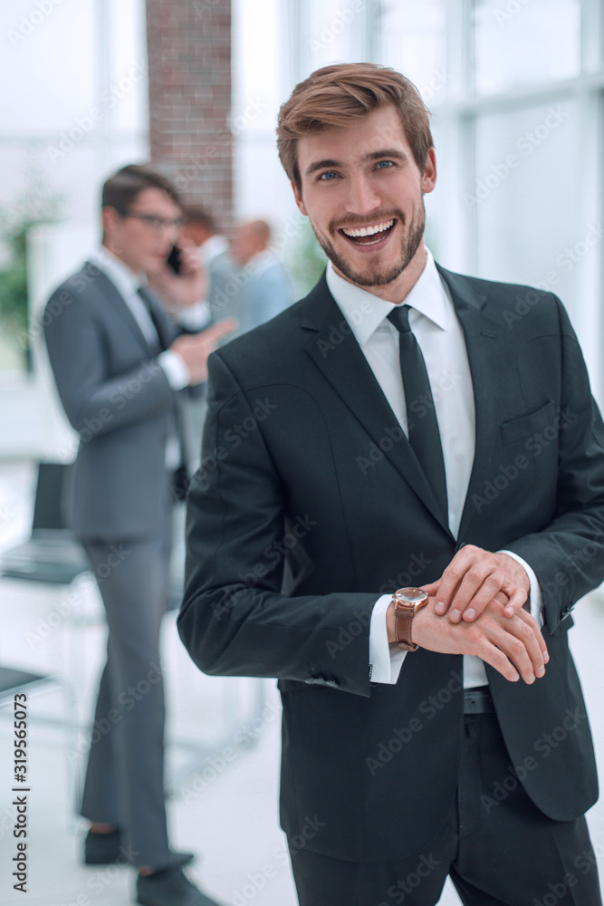 smiling business men standing in the office smiling business men standing in the office