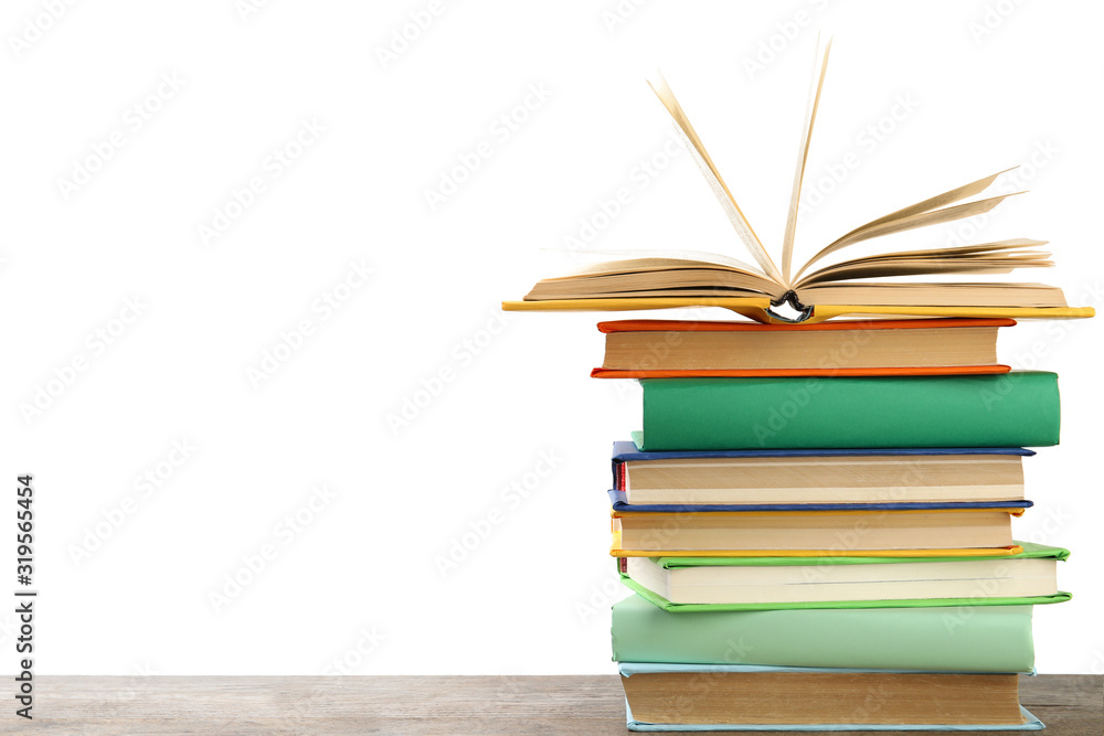 Fototapeta premium Stack of colorful books on wooden table against white background