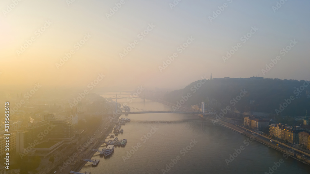 An early morning sunrise on the city capital of Hungary, Budapest. top view drone. Chain bridge on the river Danube. Views Gellert Hill with the citadel.