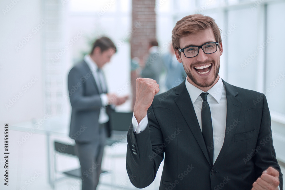 close up. happy confident businessman standing in office