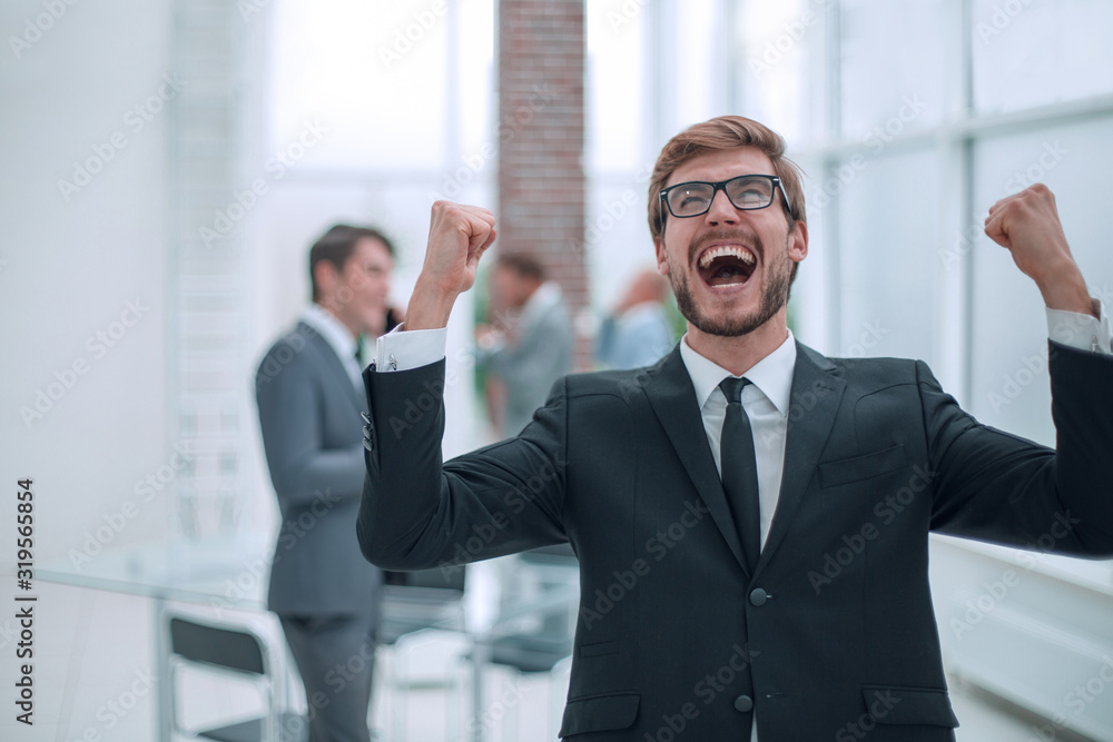 portrait of a very happy businessman on an office background portrait of a very happy businessman on an office background