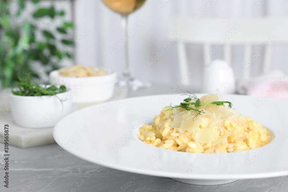 Delicious risotto with cheese on grey marble table indoors Delicious risotto with cheese on grey marble table indoors