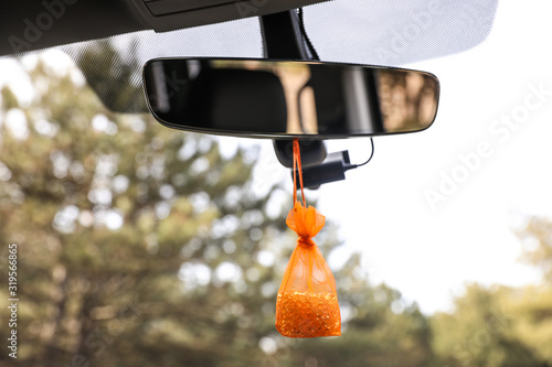 Schilderij op canvas Air freshener hanging on rear view mirror in car